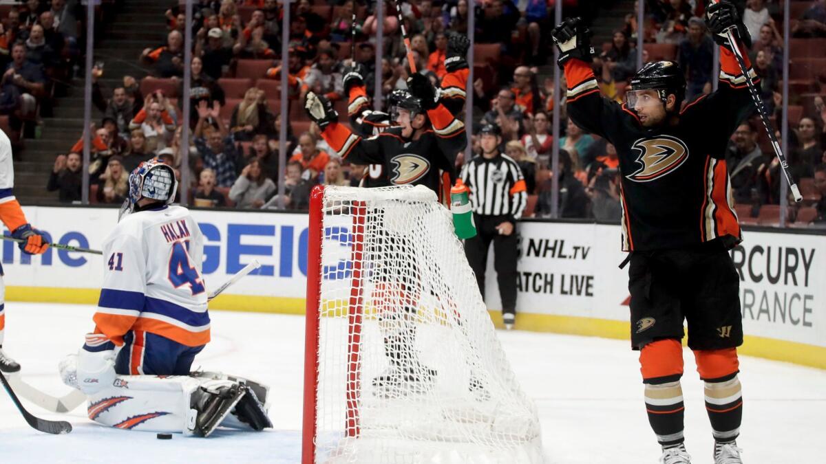 Ducks left wing Andrew Cogliano, right, celebrates after scoring past New York Islanders goalie Jaroslav Halak on Wednesday.