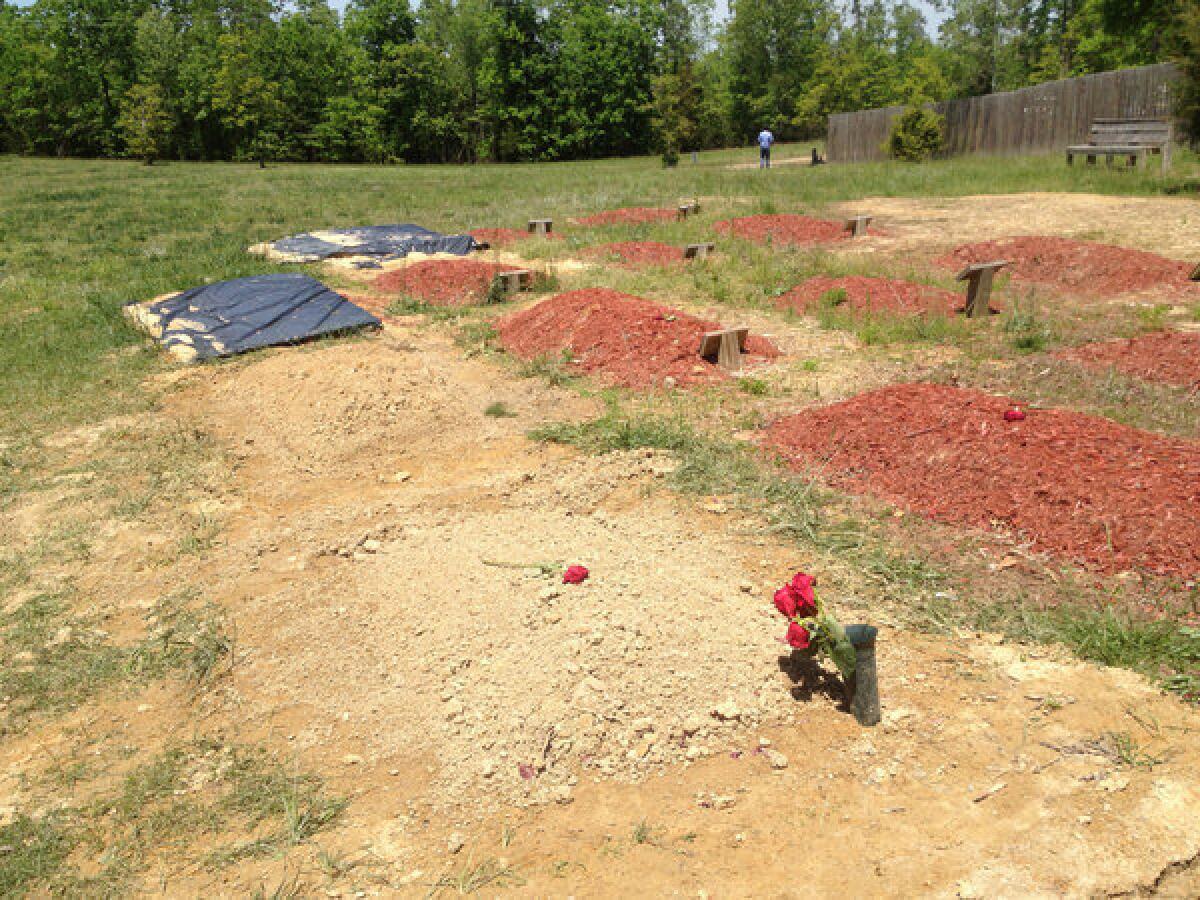 Flowers are placed on the reported burial site of Boston Marathon bombing suspect Tamerlan Tsarnaev in Doswell, Va., on Friday.