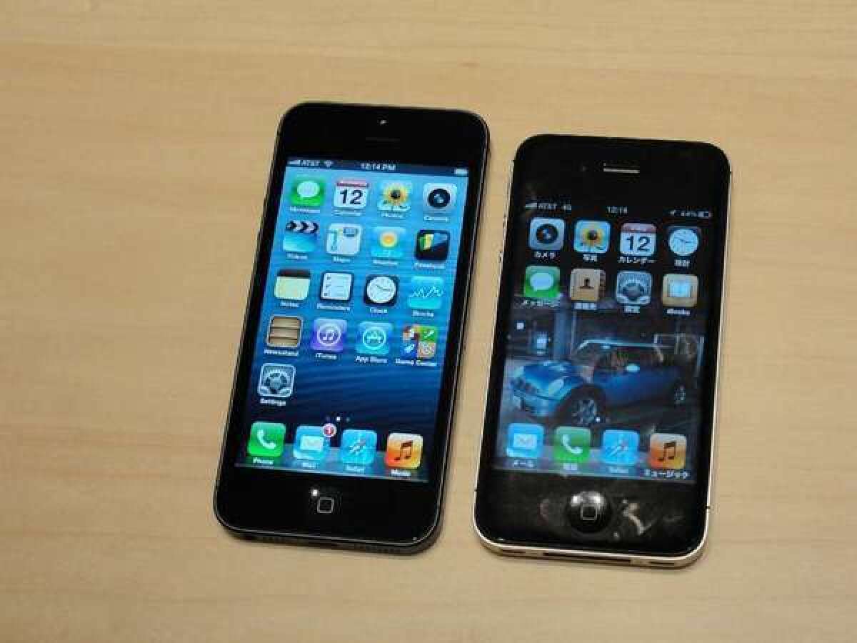 A shiny new iPhone 5 is displayed next to an iPhone 4.