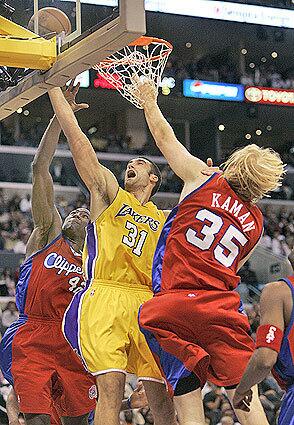 Laker Chris Mihm is stopped by Clippers Elton Brand and Chris Kaman.