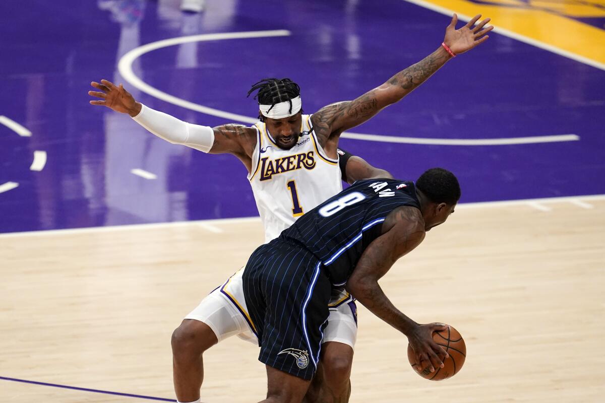 Lakers guard Kentavious Caldwell-Pope tries to cut off a drive by Magic guard Dwayne Bacon.