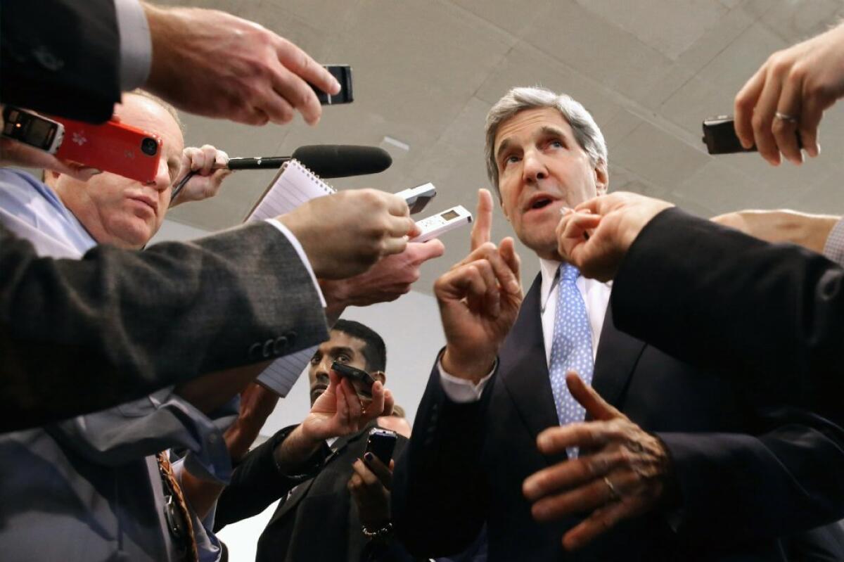 Secretary of State John Kerry speaks with reporters at the U.S. Capitol before testifying to the Senate Banking and Urban Affairs Committee on Wednesday. Kerry is asking Congress not to approve any new sanctions on Iran while negotiations continue with Tehran about its nuclear program.