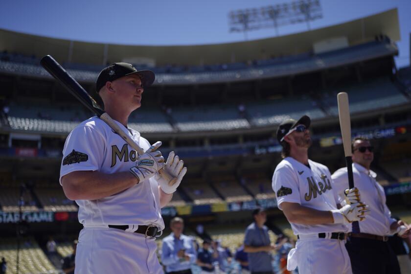 National League's Garrett Cooper, of the Miami Marlins, left, and Jeff McNeil, of the New York Mets, take batting practice before the MLB All-Star baseball game against the American League, Tuesday, July 19, 2022, in Los Angeles. (AP Photo/Jae C. Hong)