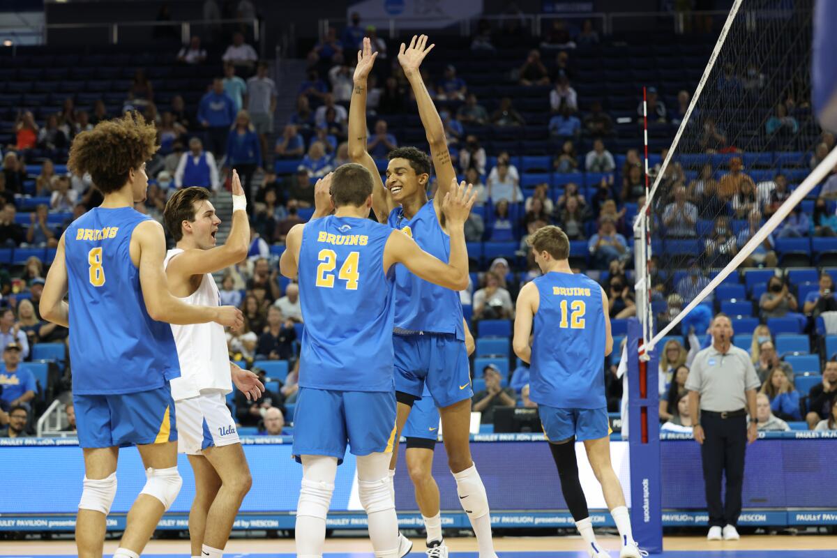 UCLA volleyball's Merrick McHenry celebrates with the team during a match against Pepperdine.