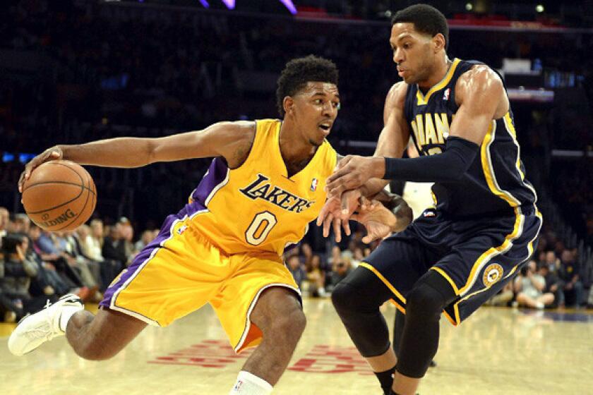 Lakers forward Nick Young drives against Pacers forward Danny Granger during a game last week at Staples Center.