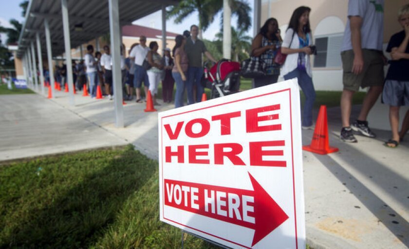 People stand in line to vote early in Pembroke Pines, Fla.