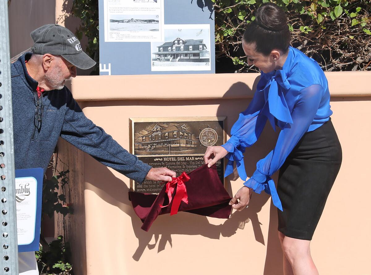 Ron Yeo and Councilwoman Lauren Kleiman, from left, unveil plaque.