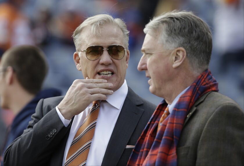 FILE - In this Sunday, Jan. 1, 2017 file photo, Denver Broncos general manager John Elway, left, stands with Broncos President and CEO Joe Ellis, right, before an NFL football game against the Oakland Raiders in Denver. The Denver Broncos' new general manager will join an organization embroiled in a family ownership feud and will work in the shadow of John Elway, whom team president Joe Ellis described as "the most important and impactful person" in franchise history.(AP Photo/Jack Dempsey, File)