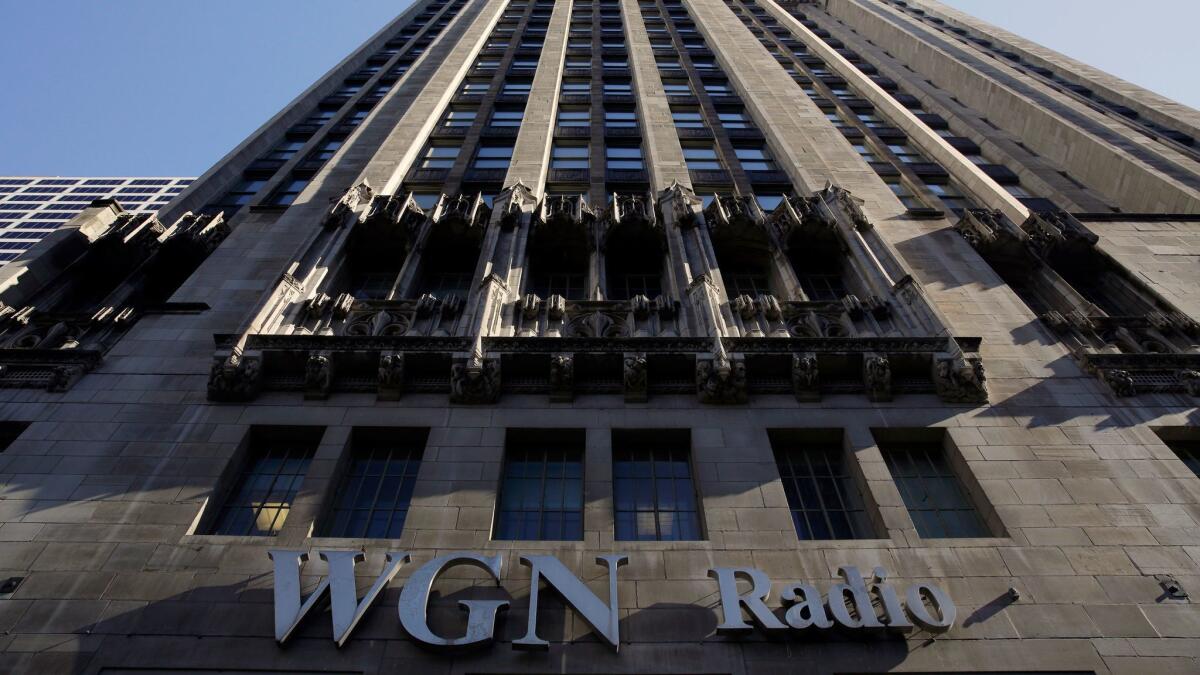 A sign for WGN Radio, part of Tribune Media, appears on the side of Tribune Tower in downtown Chicago.
