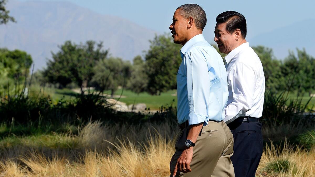 President Obama and Chinese President Xi Jinping chat as they take a walk at the Annenberg Retreat at Sunnylands in Rancho Mirage on June 8, 2013.