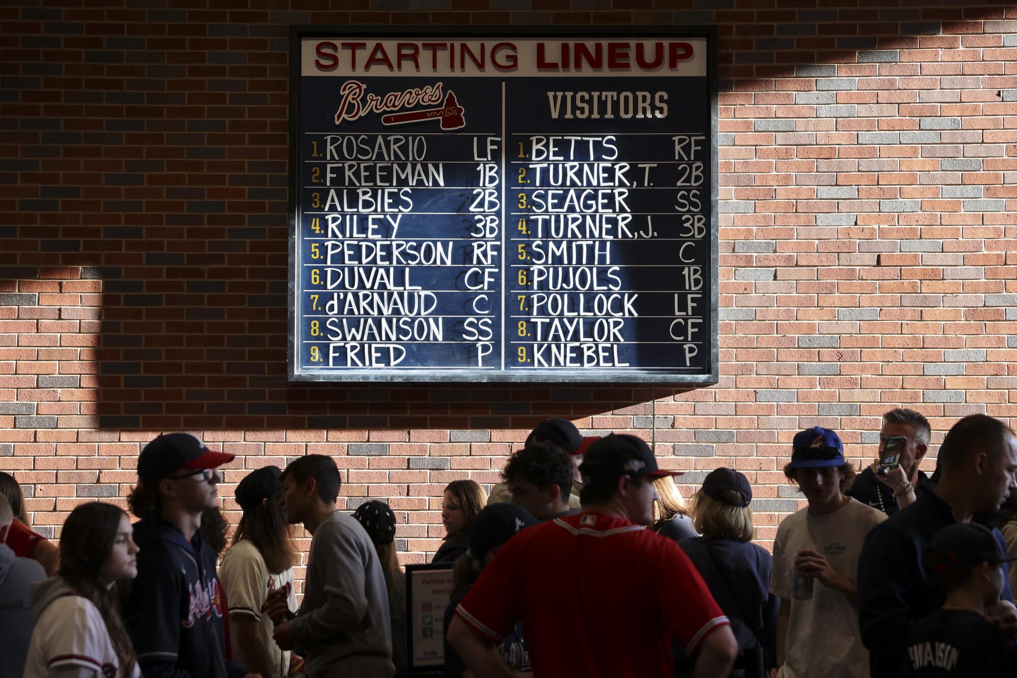 The starting lineups for the Los Angeles Dodgers and the Atlanta Braves is displayed for the fans before game one.