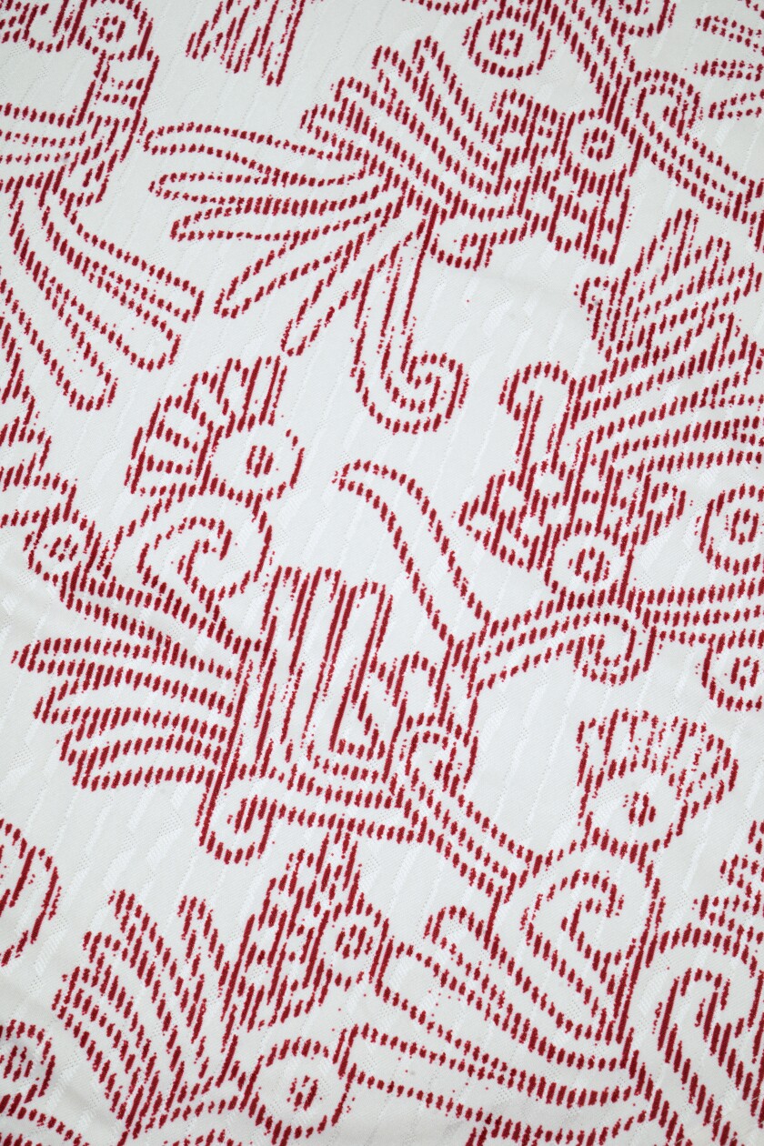 A closer look at a white shirt with red outlined designs