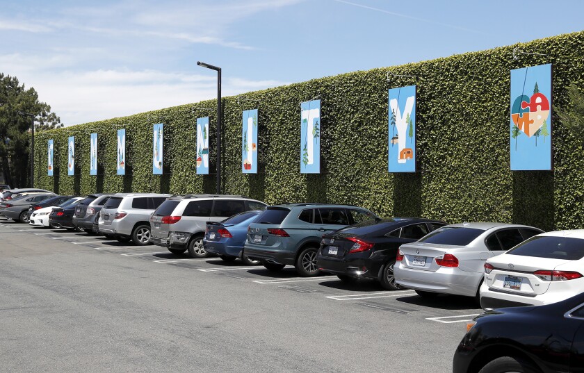 Panels spelling "community" adorn the parking lot of the CAMP retail campus in Costa Mesa.