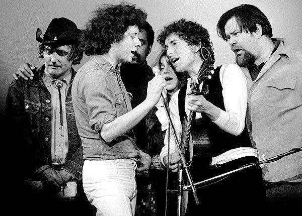 Dennis Hopper left, onstage as Bob Dylan, with guitar, Arlo Guthrie, holding mike, and others perform at a benefit at Madison Square Garden in New York on May 9 , 1974, in honor of the late Chilean President Salvador Allende. In background are film director Melvin Van Peebles and singer Melanie. At right is Dave Van Ronk.