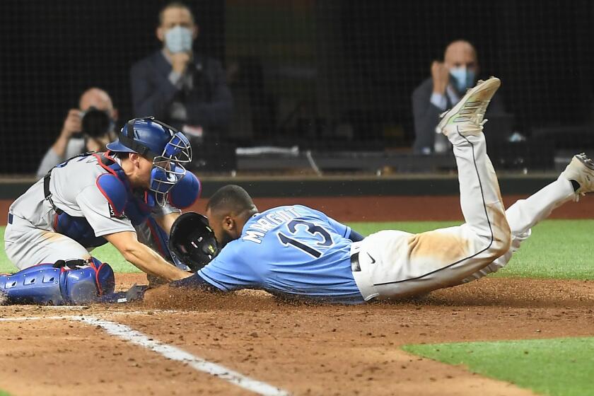 ARLINGTON, TEXAS OCTOBER 25, 2020- Dodgers catcher Austin Barnes tags out Rays Manuel Margot at home plate on a steal attempt in Game 5 of the World Series at Globe Life Field in Arlington, Texas Sunday. (Wally Skalij/Los Angeles Times)