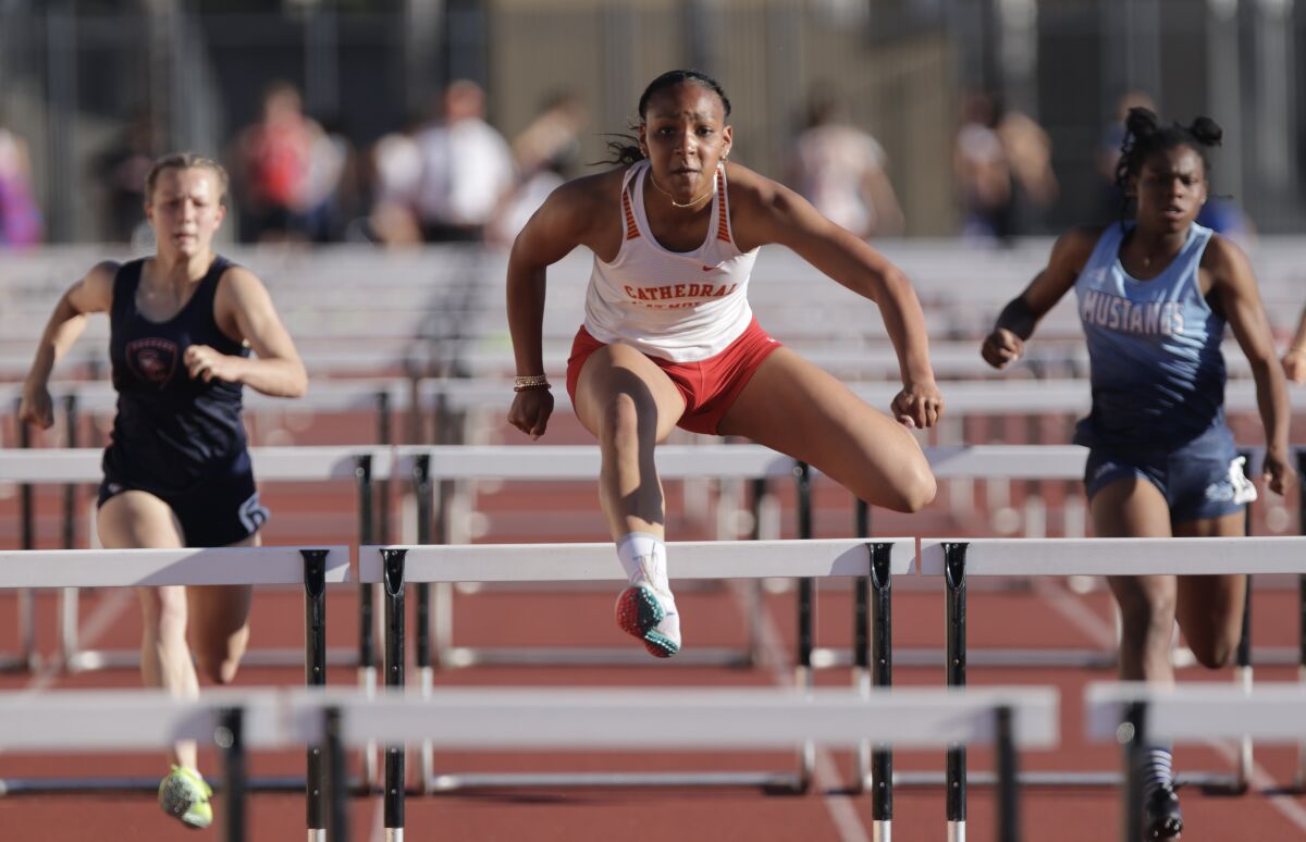 Cathedral Catholic's Kapiolani Coleman runs toward the finish to win the girls 100 hurdles during the Escondido Invitational.