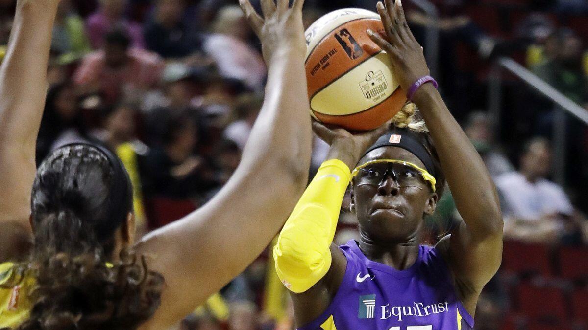 Sparks' Essence Carson (17) shoots in front of Seattle Storm's Courtney Paris in the first half of a game on July 10 in Seattle.