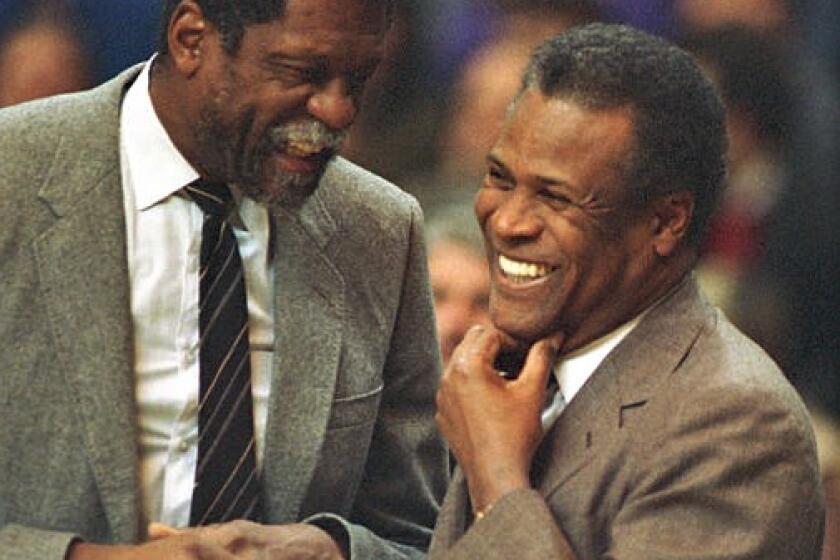 Celtics coach K.C. Jones, right, greets Sacramento coach and former teammate Bill Russell during an NBA game in 1988.