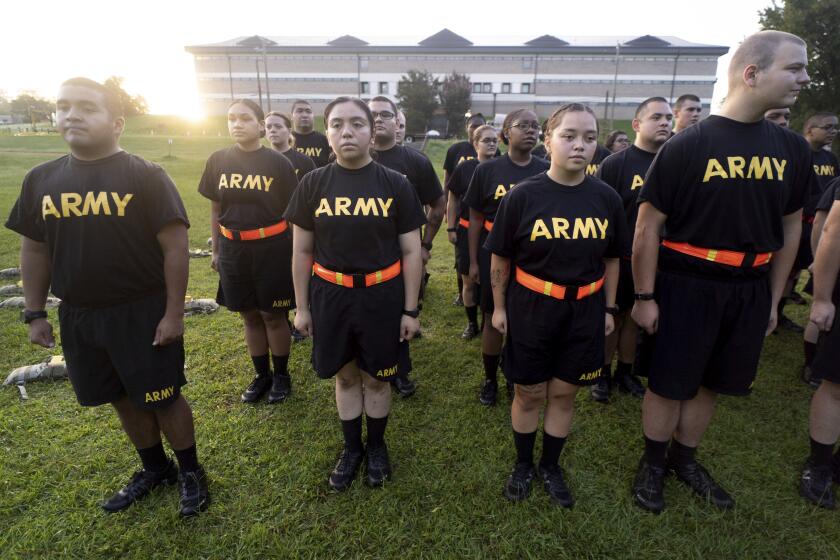 FILE - Students in the new Army prep course stand at attention after physical training exercises at Fort Jackson in Columbia, S.C., Aug. 27, 2022. The Army is launching a sweeping overhaul of its recruiting to focus more on young people who have spent time in college or are job hunting early in their careers. The aim is to reverse years of enlistment shortfalls. (AP Photo/Sean Rayford, File)