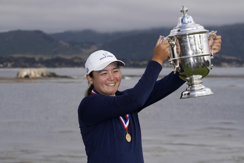 Allisen Corpuz poses with the winner's trophy after the U.S. Women's Open golf tournament at the Pebble Beach Golf Links.