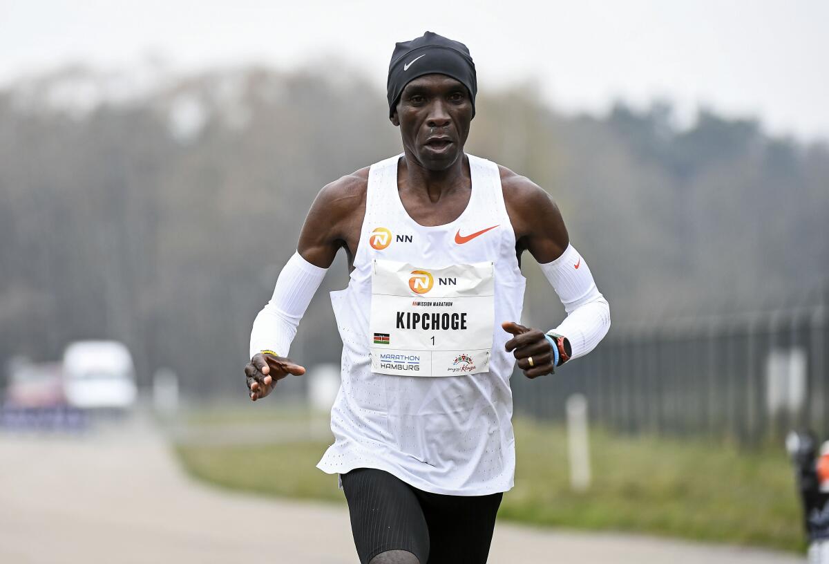 FILE - In this April 18, 2021, file photo, Eliud Kipchoge of Kenya runs to win the NN Mission Marathon at Enschede Airport in Enschede, Netherlands. The Olympic marathons, along with the race walks, were shifted a four-hour train ride north to Sapporo because of the extreme heat in Tokyo. Kipchoge is the defending champion. (Piroschka van de Wouw/Pool Photo via AP, File)