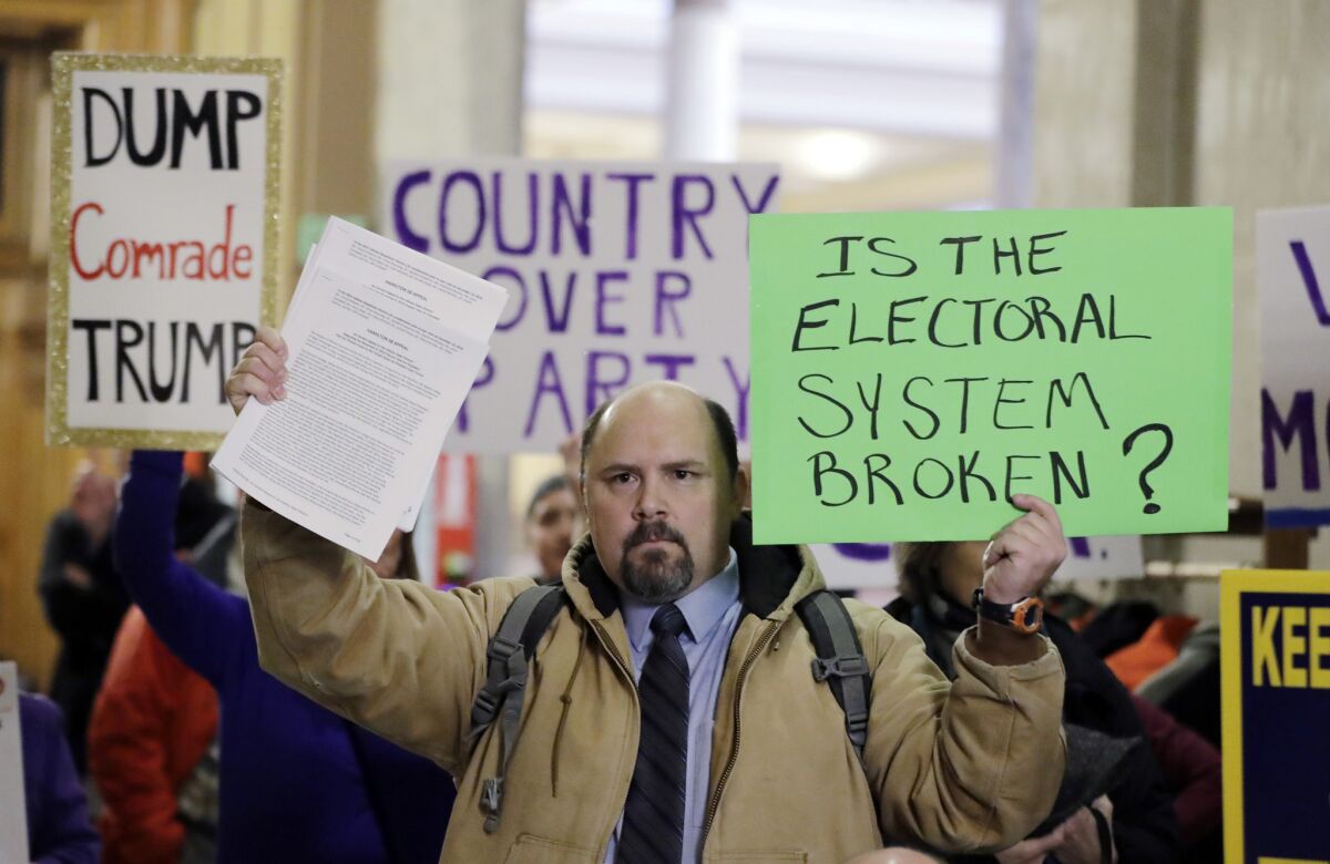 Protesters demonstrate outside the Indiana House chamber before the state's electors cast their ballots for Donald Trump in 2016.