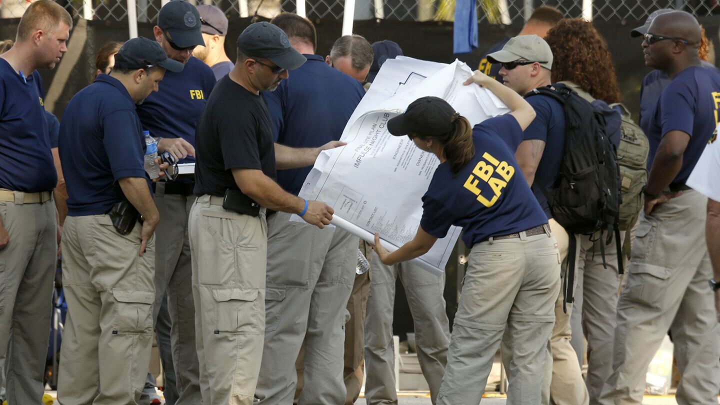FBI investigators in Orlando, Fla., look at the floor plans of Pulse nightclub as they gather on Monday morning to continue the investigation.