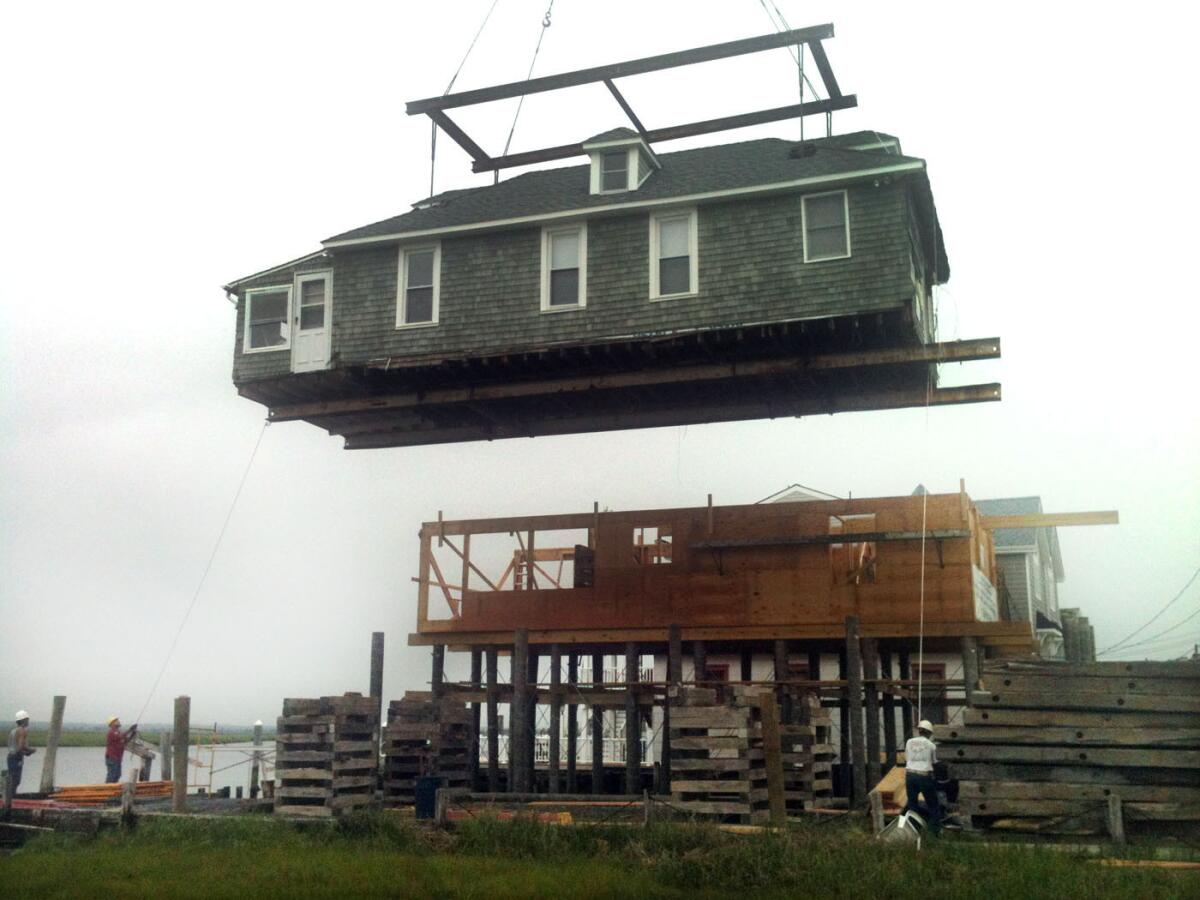 A home in Sea Isle City, N.J., is moved to an adjoining property to correct damage issues inflicted by Superstorm Sandy.