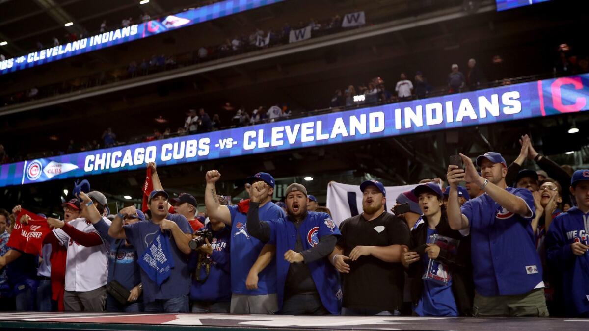 Chicago Cubs fans cheer after their team defeated the Cleveland Indians, 9-3, at Progressive Field on Nov. 1.