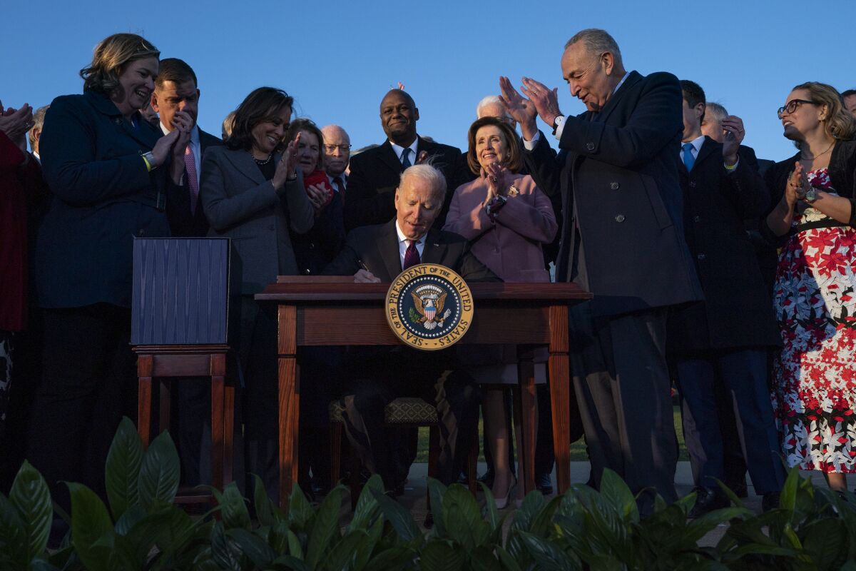 President Joe Biden signs the "Infrastructure Investment and Jobs Act" during an event on the South Lawn of the White House, Monday, Nov. 15, 2021, in Washington. (AP Photo/Evan Vucci)
