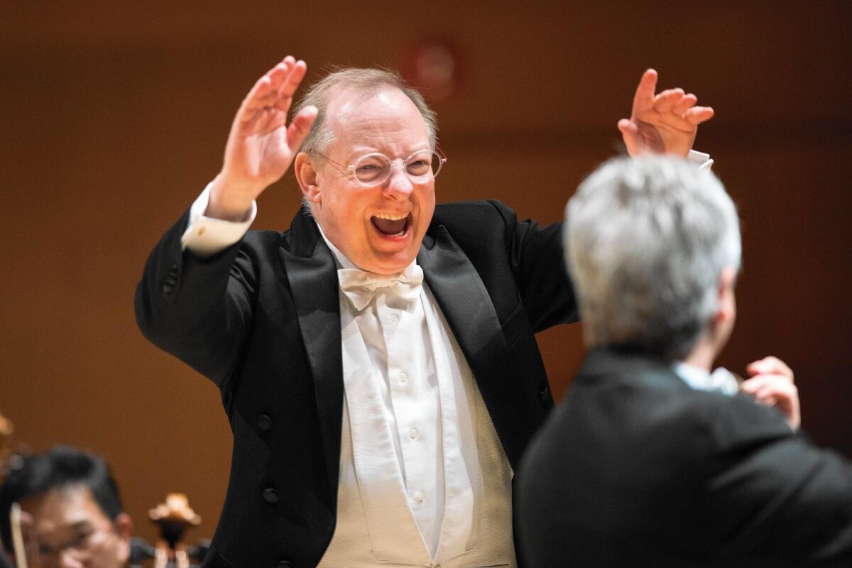 Nicholas McGegan conducts the L.A. Philharmonic as principal concert master Martin Chalifour, right, performs at Disney Hall following their return from a European tour.