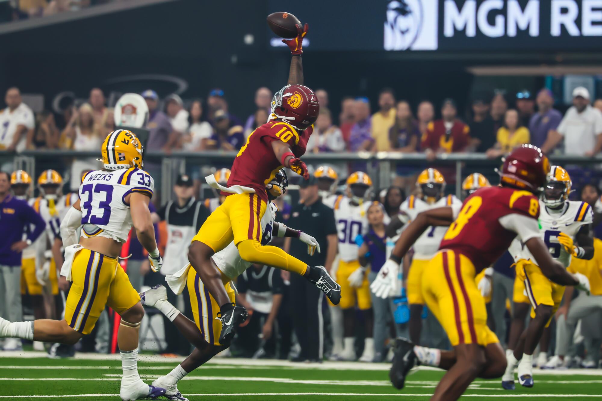 USC receiver Kyron Hudson leans backward and makes a one-handed catch against LSU Sunday at Allegiant Stadium