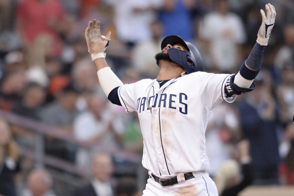 Fernando Tatis Jr. gestures as he crosses the plate following his two-run homer in the fifth inning of the Padres' game against the Giants Saturday at Petco Park.