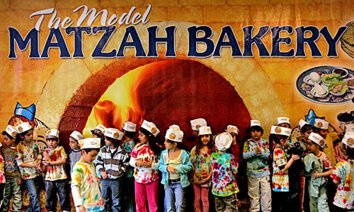 MAKING MATZO: Kids learn how to make matzo before Passover each year at the Model Matzah Bakery in Westwood.