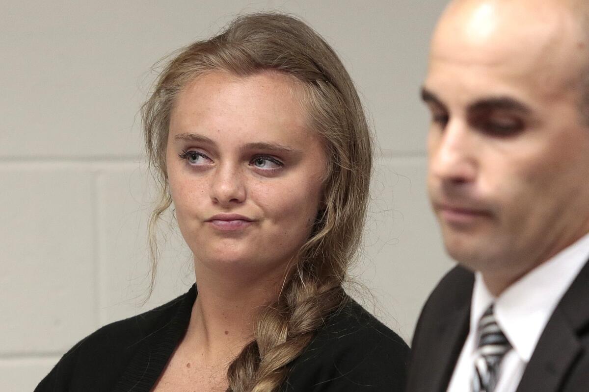 Michelle Carter listens to defense attorney Joseph P. Cataldo argue for an involuntary manslaughter charge against her to be dismissed at Juvenile Court in New Bedford, Mass.