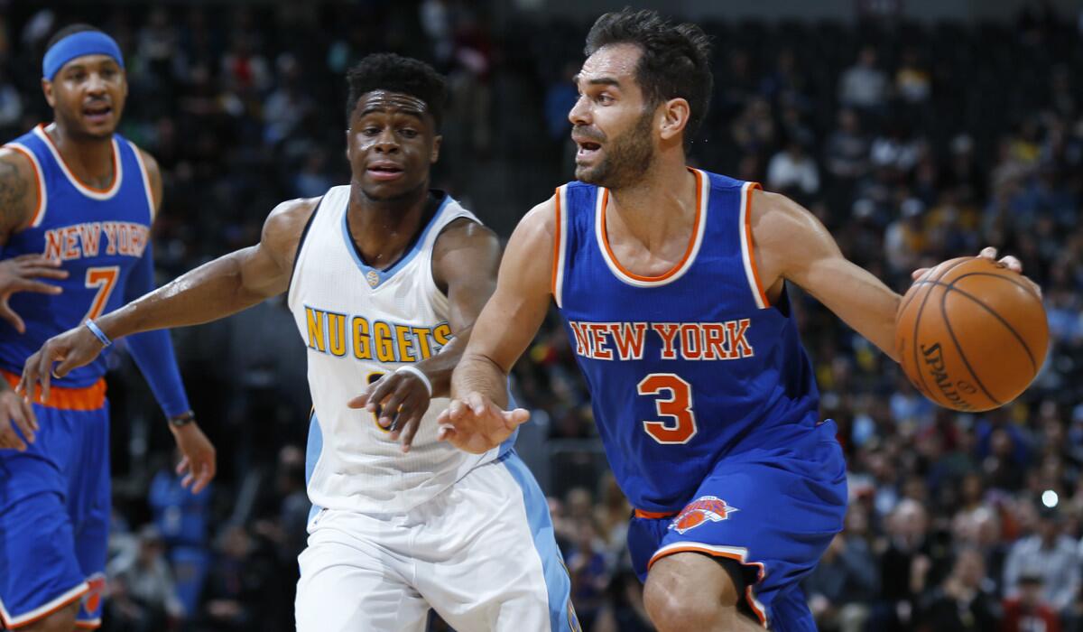 Former New York Knicks guard Jose Calderon, front, drives past Denver Nuggets guard Emmanuel Mudiay during the first half of a game March 8.