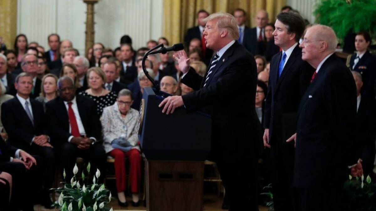 President Trump, with Justice Brett Kavanaugh and retired Justice Anthony M. Kennedy, speaks during Kavanaugh's ceremonial swearing-in.