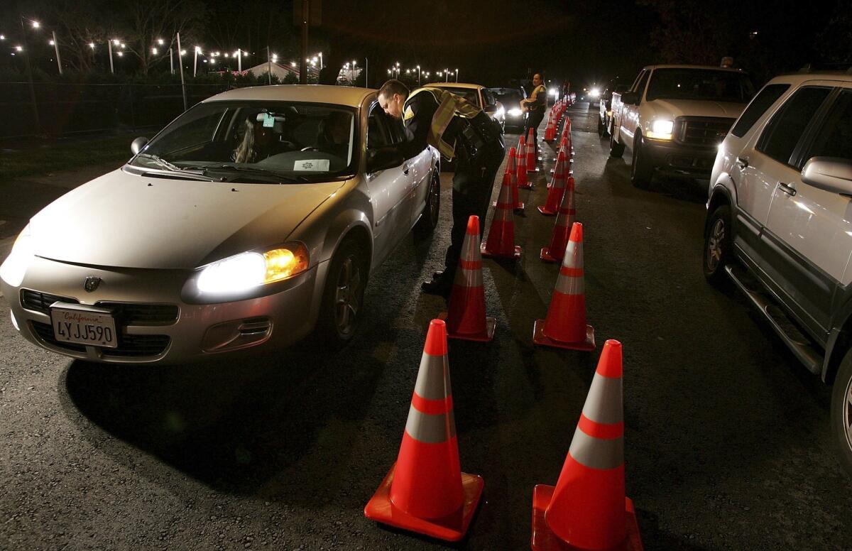 San Bruno police officers stop cars at a DUI checkpoint. State officials are proposing to make it an infraction to use marijuana in motor vehicles.