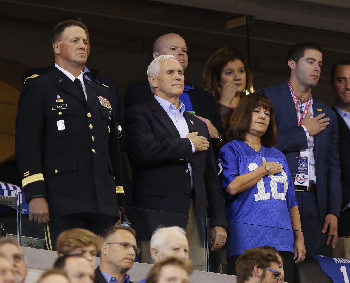 Vice President Mike Pence, front center, stands during the playing of the national anthem at the Indianapolis Colts and the San Francisco 49ers football game on Sunday.