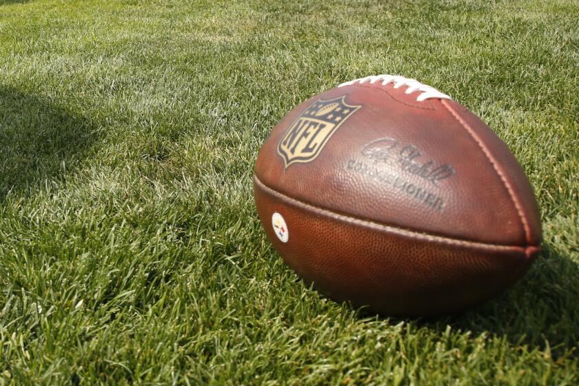 An NFL football sits on the practice field as the Steelers practice during training camp in Latrobe, Pa.