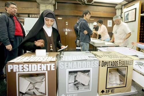 A nun casts her ballot during the genera