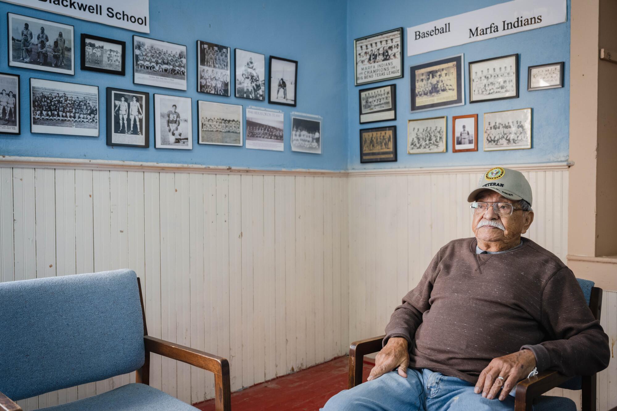 A man sits in a chair.