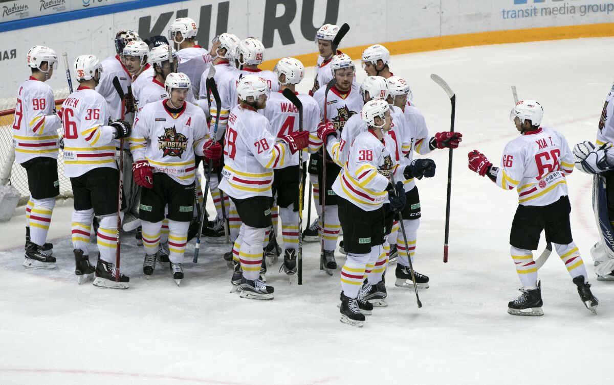 FILE - Kunlun Red Star's team players celebrate after they won the Kontinental Hockey League match against Spartak Moscow, Oct. 1, 2016, in Moscow, Russia. Next week near Moscow, China will play two games as Beijing-based KHL team Kunlun Red Star against Russian opponents. IIHF and Chinese hockey officials will be watching closely, in person and online, and hoping the team is not going to be embarrassed against NHL competition at the Winter Games in February. (AP Photo/Pavel Golovkin, File)