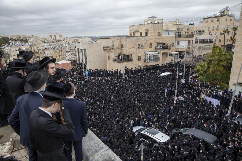 Thousands of ultra-Orthodox Israelis attend a funeral for a prominent rabbi in Jerusalem on Sunday.