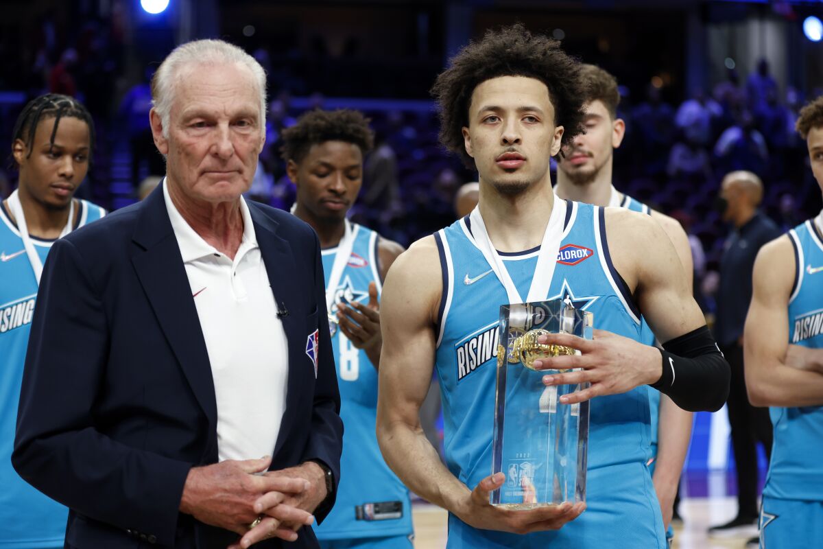 Team Barry's Cade Cunningham stands with honorary coach Rick Barry after being named MVP of the Rising Stars event.