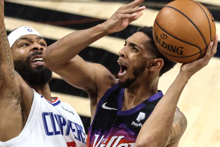Tuesday, June 22, 2021, Phoenix, Arizona -Phoenix Suns guard Cameron Payne (15) shoots over LA Clippers forward Marcus Morris Sr. (8) in Game two of the NBA Western Conference Finals at Phoenix Suns Arena. (Robert Gauthier/Los Angeles Times)