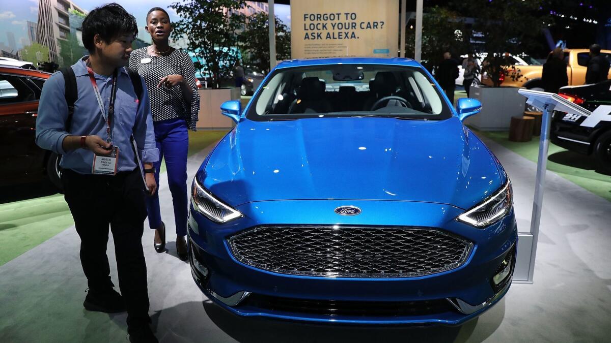 The new Ford Fusion is on display at the New York International Auto Show in March. The car company plans to stop investing in most sedans so it can focus on more profitable SUVs and pickup trucks.