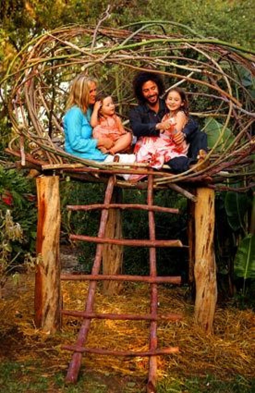 Ilse Ackerman, Meeno Peluce and their daughters get cozy in the nest the couple built from repurposed eucalyptus in the yard of their Lincoln Heights home. From left, Ackerman, Mette, Peluce and India. The nest, inspired by the Spirit Garden in Big Sur, "challenges the kids to climb and balance," Ackerman says. The two crafted the nest from discarded eucalyptus they found on a neighboring hillside. "We rented a chain saw," Peluce says. "Someone cleared the hillside and just left the wood." More... • A country escape in urban L.A. Also in Home & Garden • Design Dispatch: International Contemporary Furniture Fair • Photos: Furniture Fair picks • Reality Check: Infrared barbecues • Centuries later, the hammock is still swinging