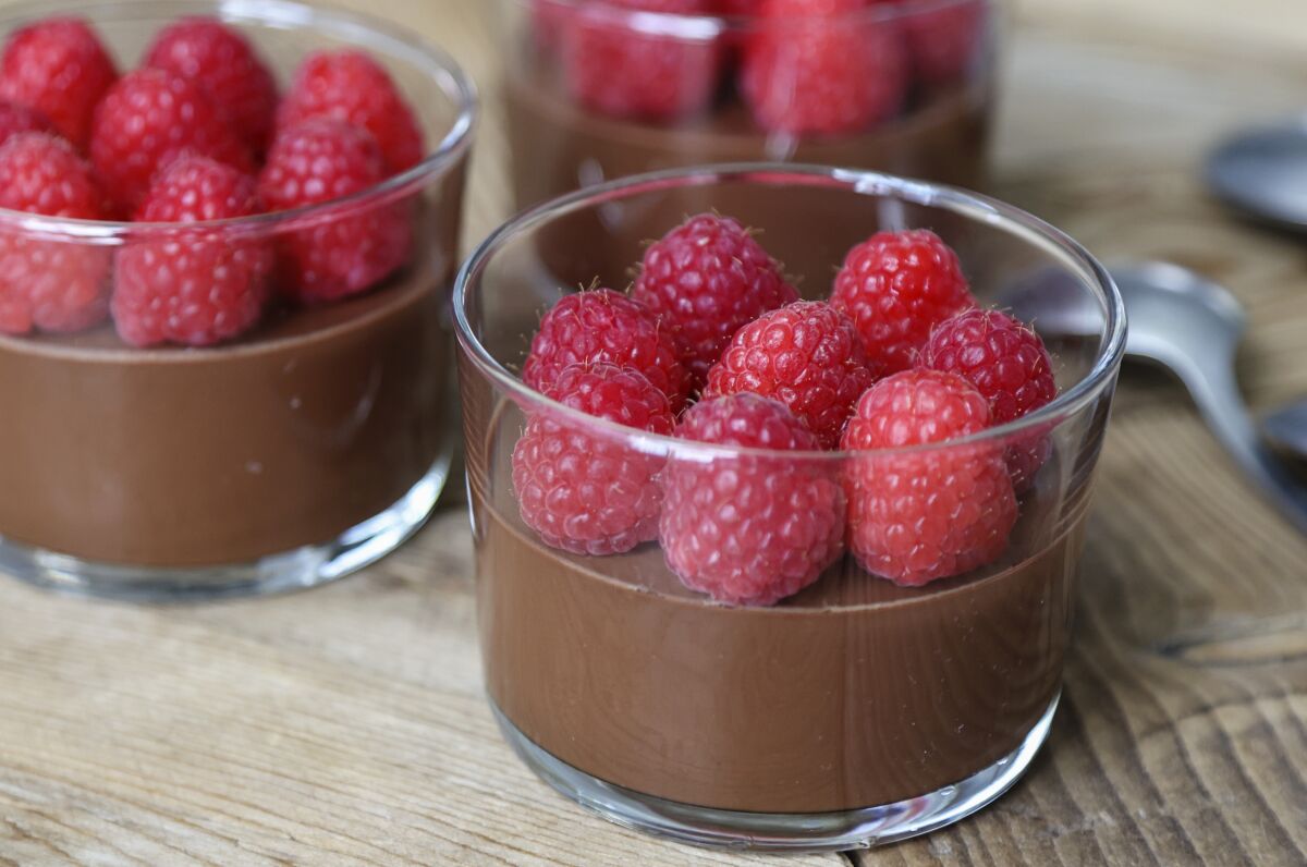 Dark chocolate pots de creme with fresh raspberries.