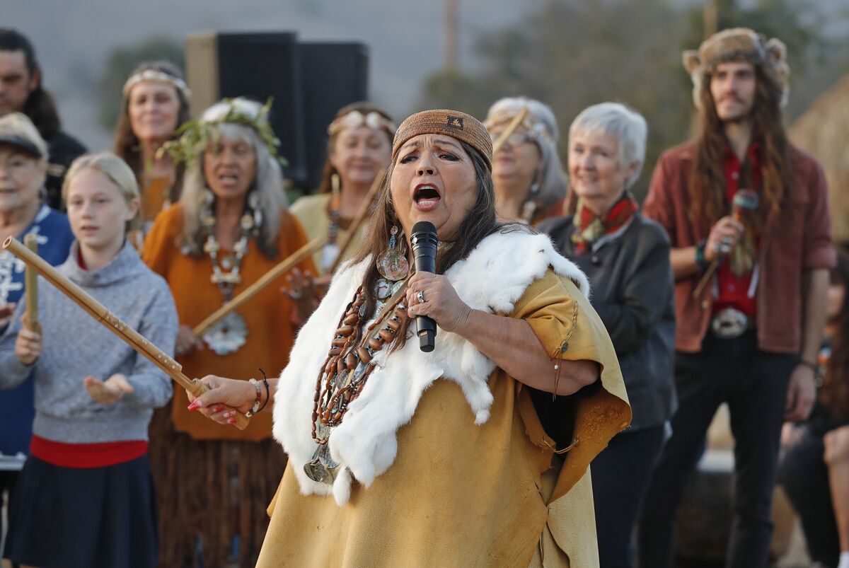 Native American storyteller Jacque Nuñez leads guests in a traditional song.
